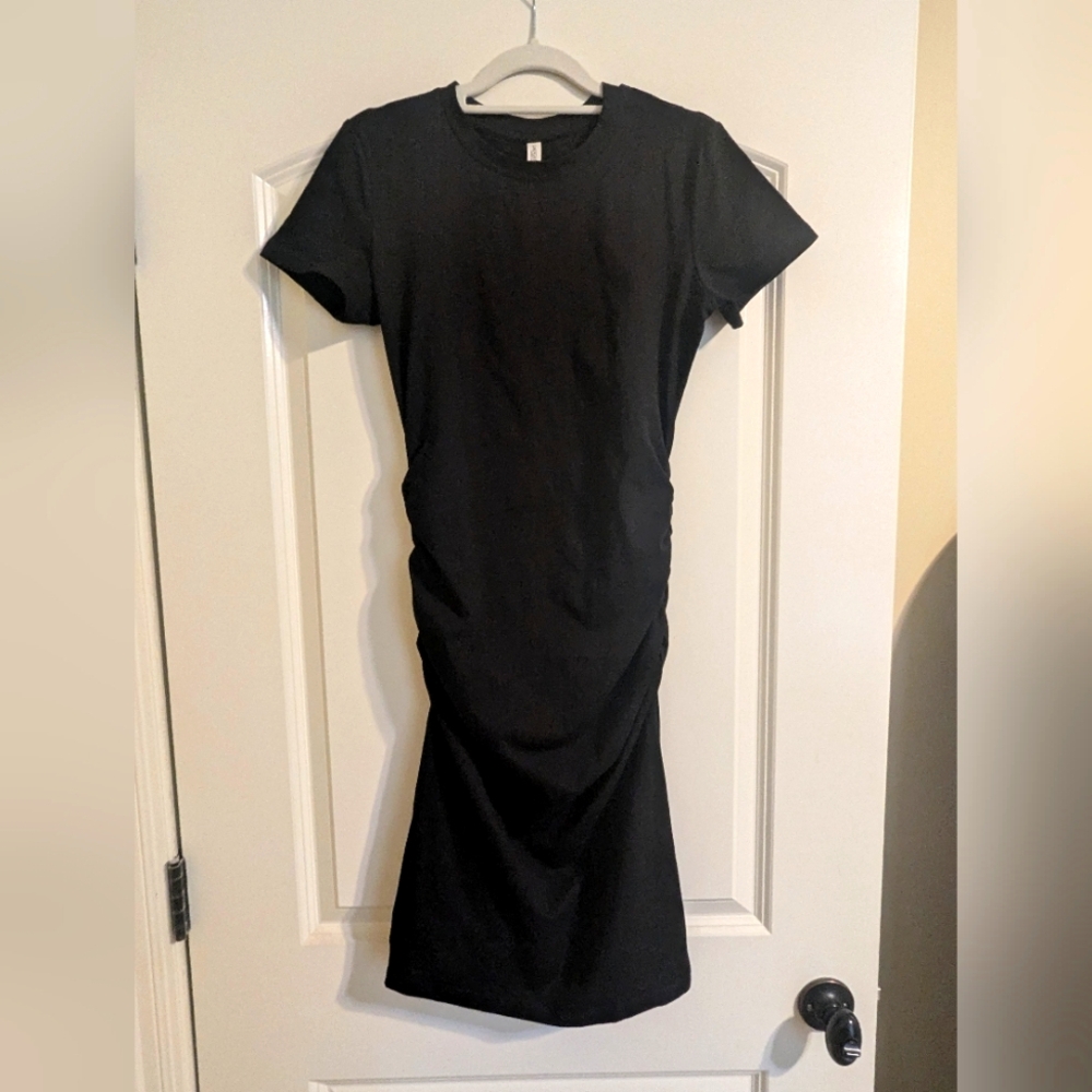 Brand new, never worn small black knee-length dress, without tags